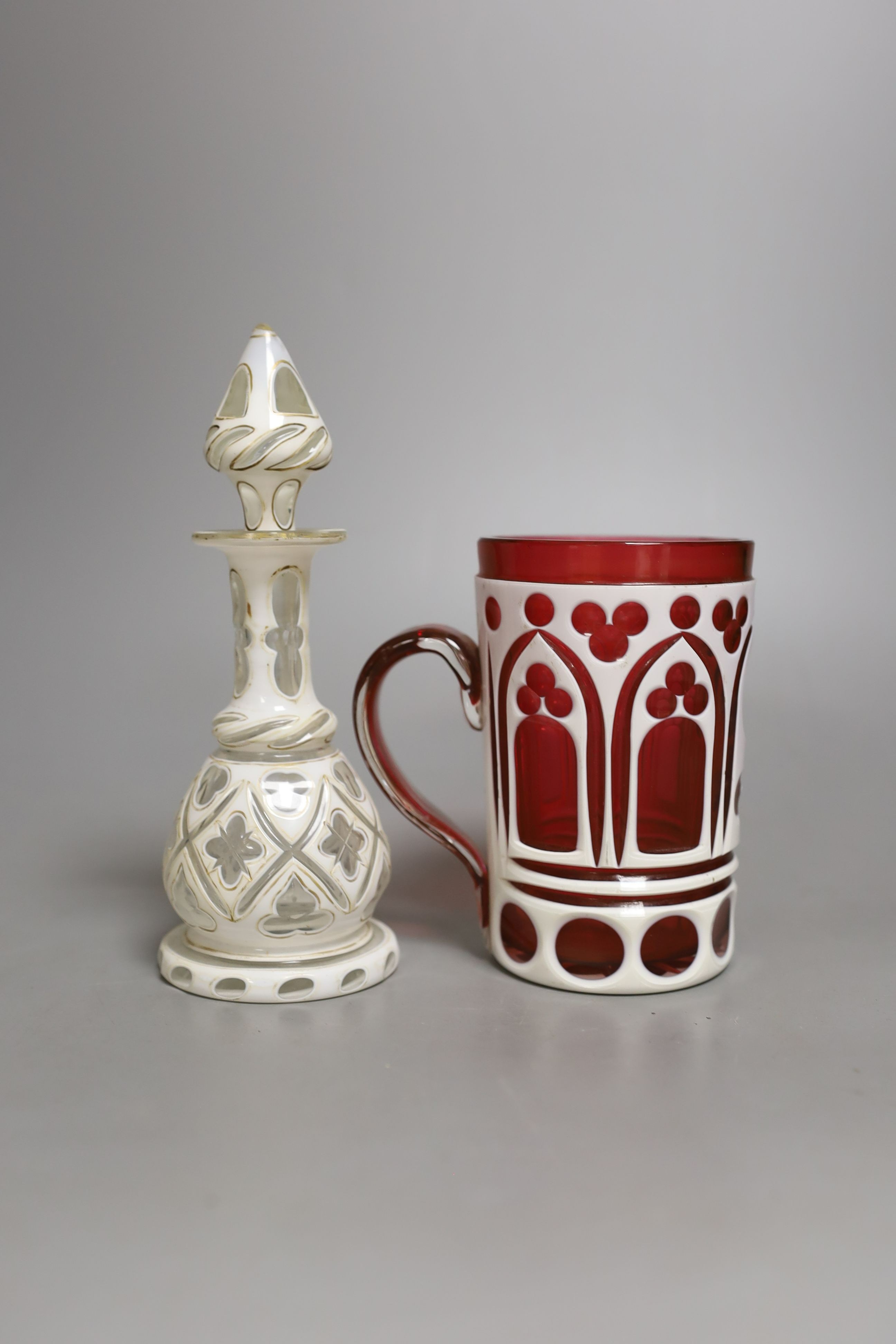 A Bohemian cranberry overlay mug and similar white overlay scent bottle, Scent bottle 17 cms high.